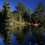 How To Paddle Your Canoe Silently canoeist paddles a canoe silently across still water