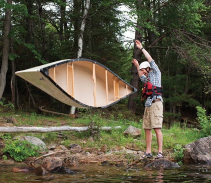 Scott MacGregor flipping the Nova Craft Prospector 16 TuffStuff canoe onto the ground while laughing