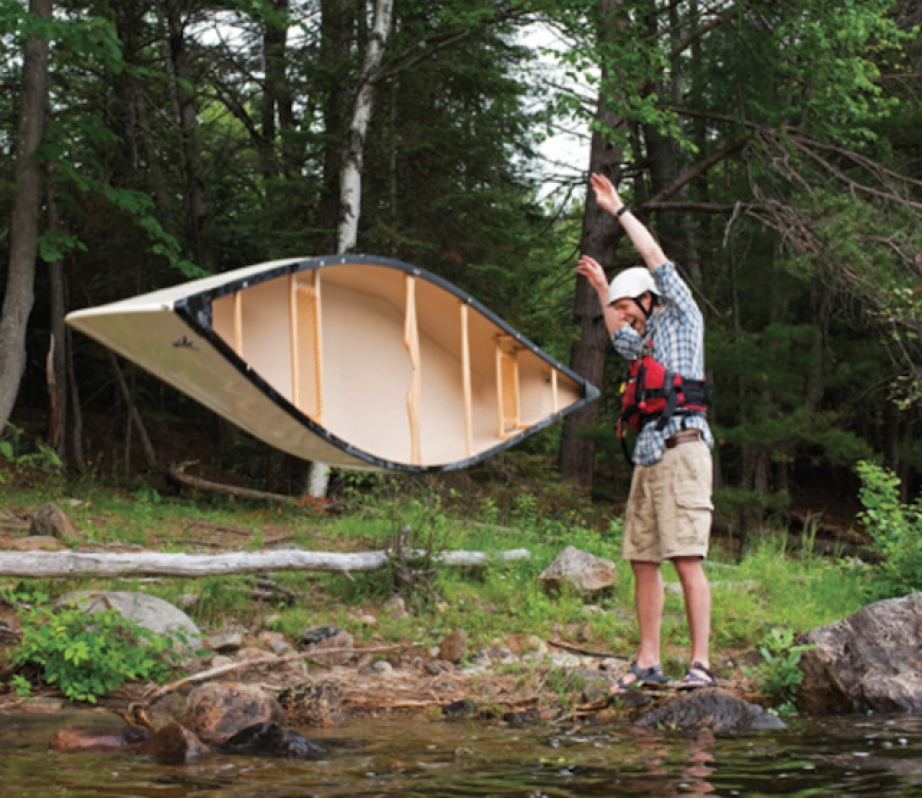 Scott MacGregor flipping the Nova Craft Prospector 16 TuffStuff canoe onto the ground while laughing