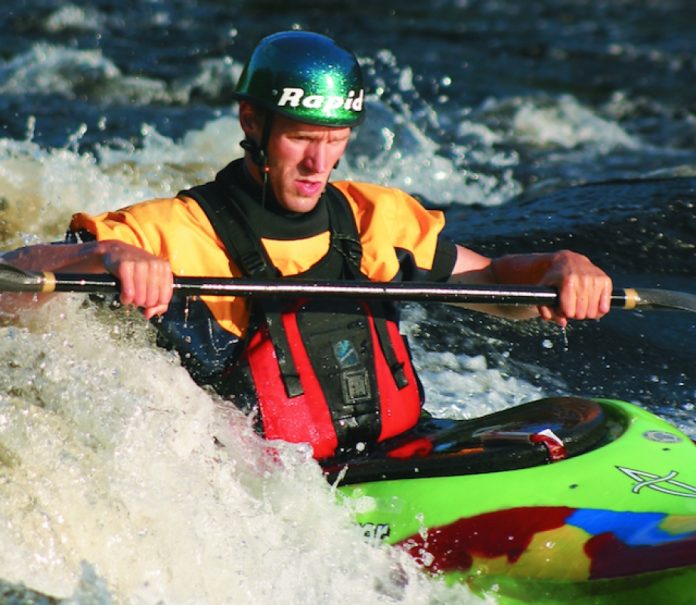 Scott MacGregor surfing on a wave on the Ottawa River in Dagger Kayak's GT