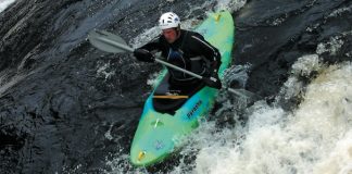 kayaker paddling down a rapid in Pyranha's H:3 river running kayak