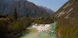 Descending the Soča from source to sea, the flotilla of kayakers paddling in support of free flowing rivers drift through the emerald waters in Slovenia on their way to Italy. Photo: Jan Pirnat