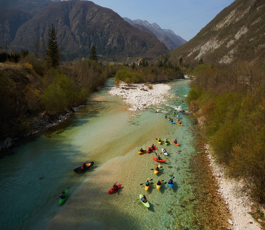 Descending the Soča from source to sea, the flotilla of kayakers paddling in support of free flowing rivers drift through the emerald waters in Slovenia on their way to Italy. Photo: Jan Pirnat