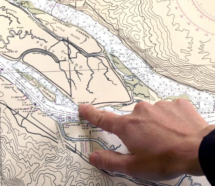 A kayaker plans his trip on a map before going out on the water.