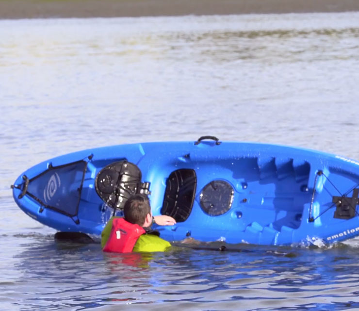 Paul Kuthe flips his kayak right side up.