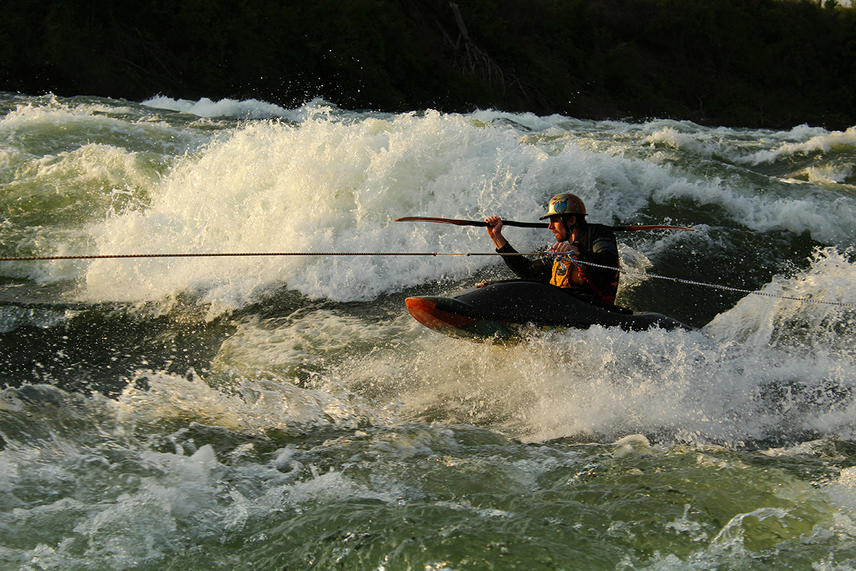 During a sunset session Ottawa Valley paddler Brendan Kraiker uses the rope to tow on to Nile Special.