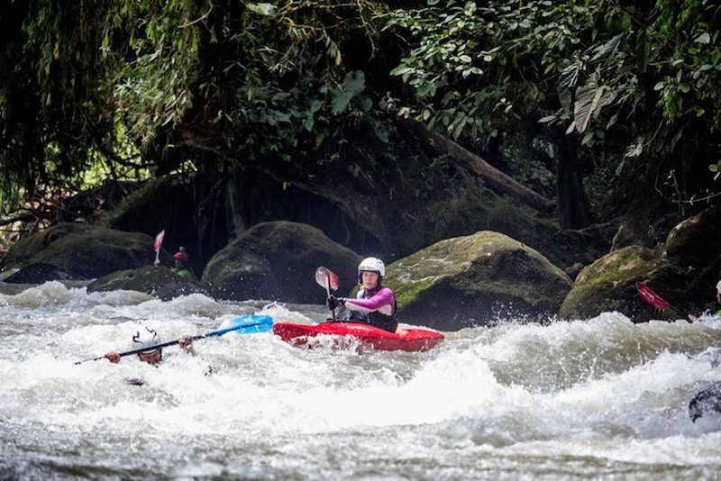 Two whitewater kayakers on a river in Costa Rica