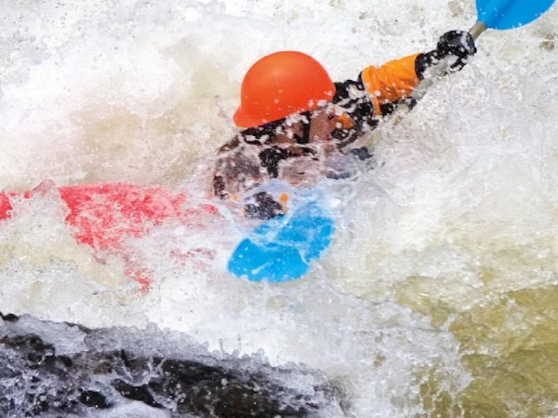 A whitewater kayaker demonstrates how to escape a hydraulic
