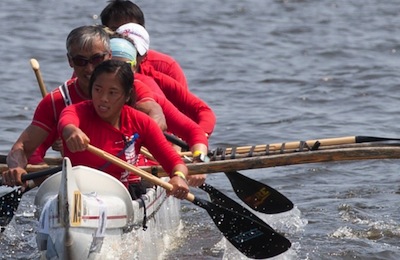 A team of paddlers participate in a canoe race