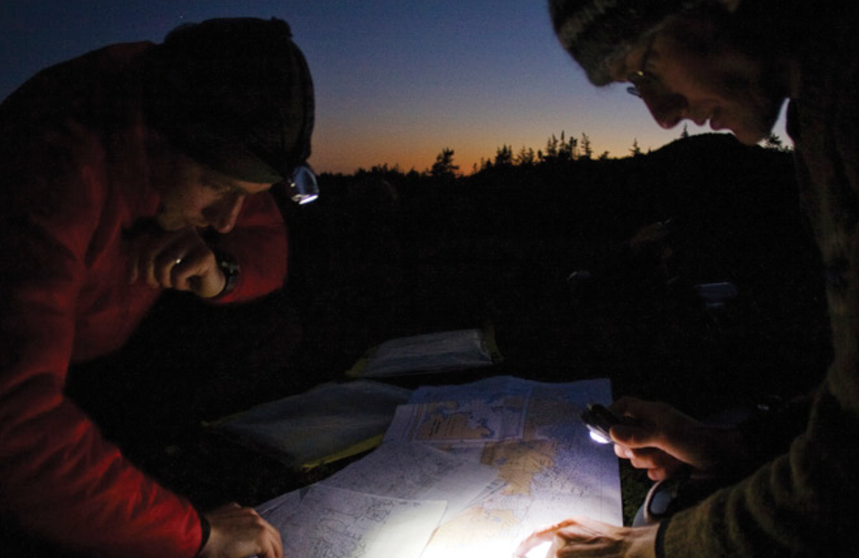 People looking at map for kayak expedition