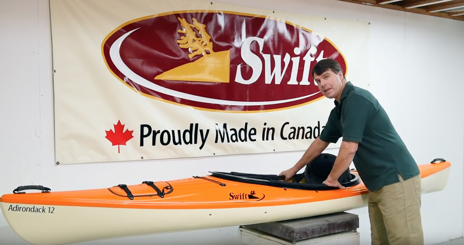 Bill Swift stands in front of the updated Adirondack 12  recreational kayak.