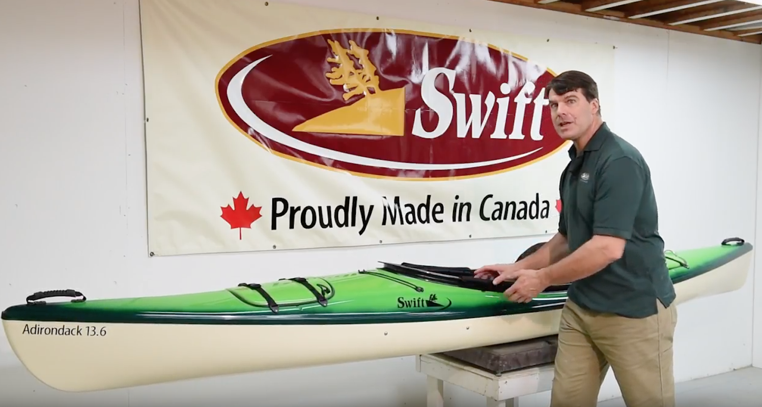 Bill Swift stands in front of the updated Adirondack 13.6  recreational kayak.
