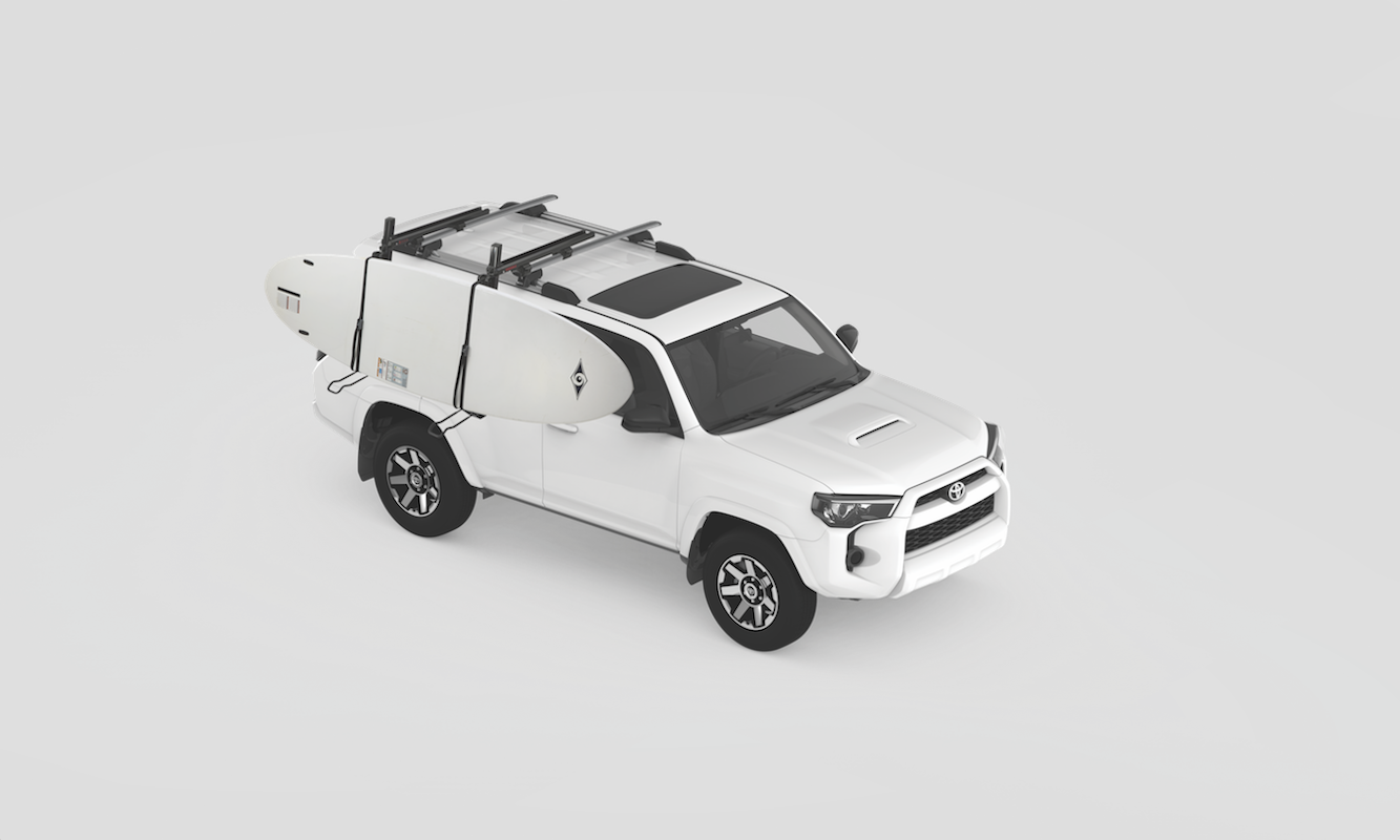 The Yakima ShowDown drop down roof rack with two standup paddleboards strapped to the side.