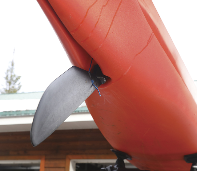 Fin on bottom of orange kayak