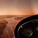 8 Expert Tips For A Fly-In Canoe Adventure view of a river from a planes cockpit