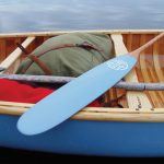 Tom Thomson’s Limited Edition Canoes painted paddle sitting across canoe