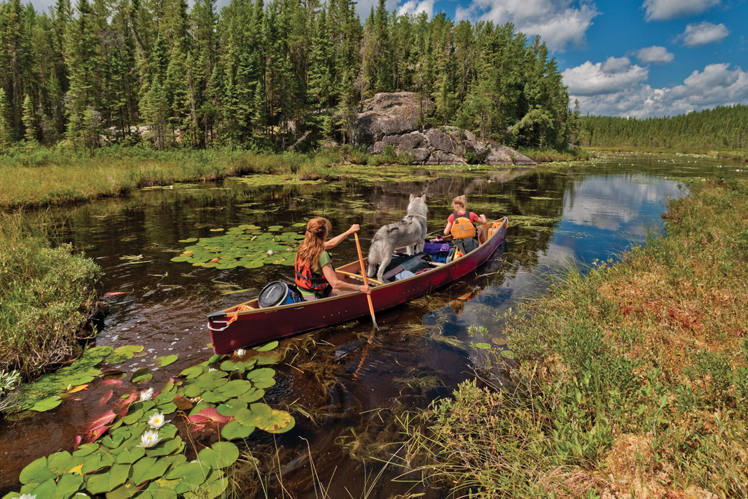 Two people on a canoe trip through a lake in the Souris River Quetico 18.5