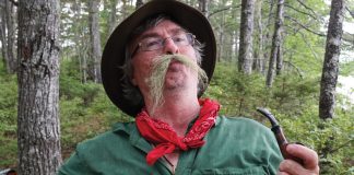 man in woods with a fake moustache