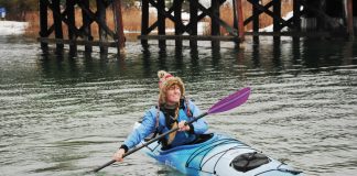 Woman paddling in an Old Town Castine touring kayak