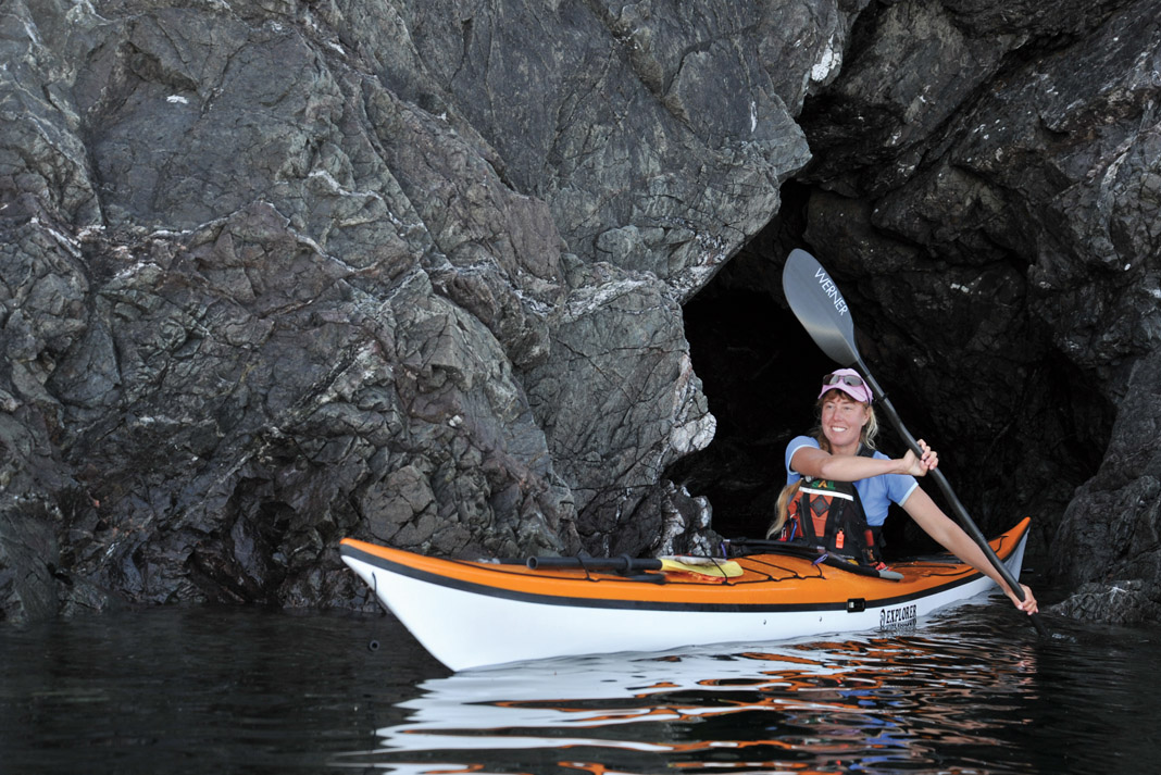 woman paddling an explorer sea kayak