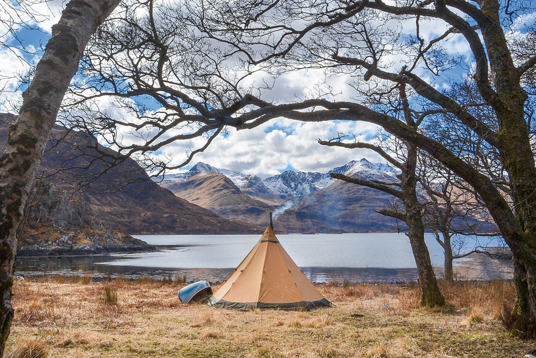 tent and canoe set up side of lake in Scotland