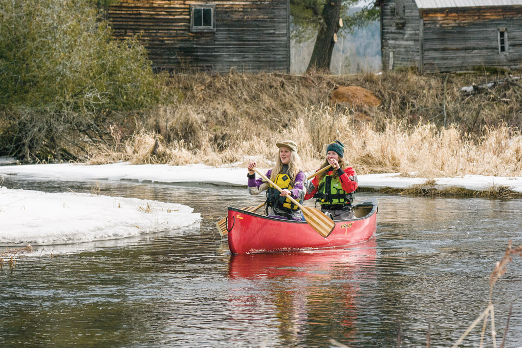 two women paddling a protecter 15 canoe