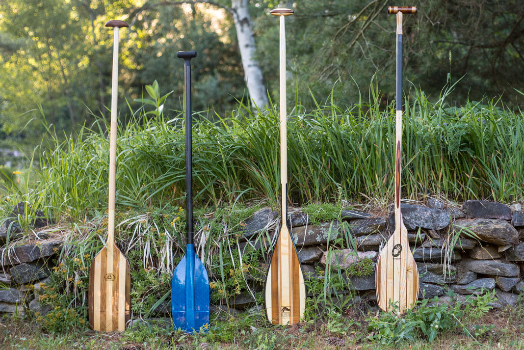 4 canoe paddles standing in a row