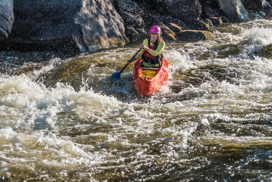 Mel Lindsay paddling Esquif Canoe's OC1 canoe down a rapid