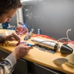 Chris Vermeulen Builds DIY Paddleboard Jet Drive man putting a motor on a paddleboard