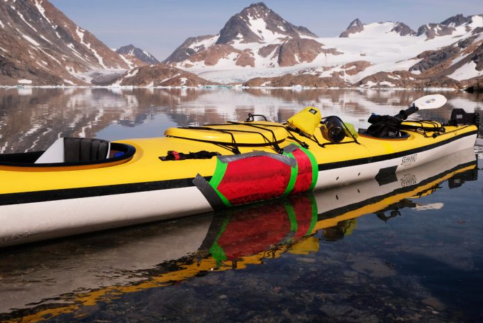 A sea kayak with patches from a kayak repair kit