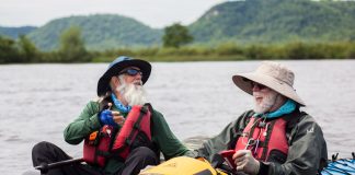 two men in kayaks laughing