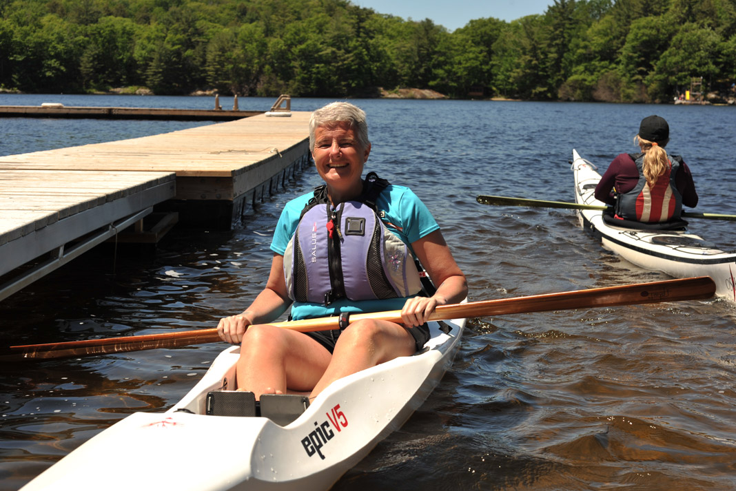woman one a white open kayak