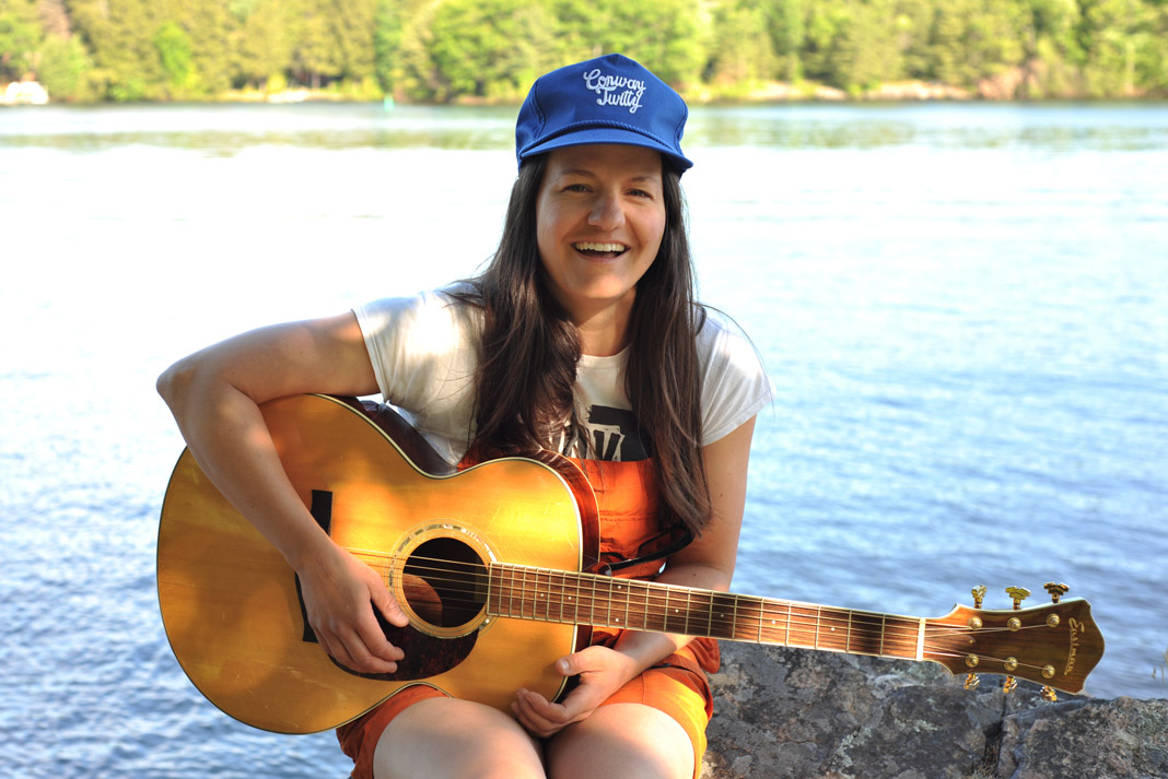 woman smiling with a guitar