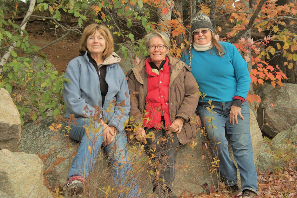 three women smiling at the camera