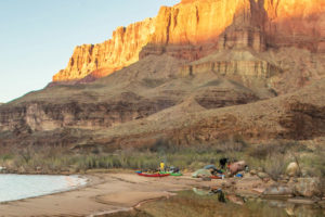 campsite in Grand Canyon with a sunset and kayaks