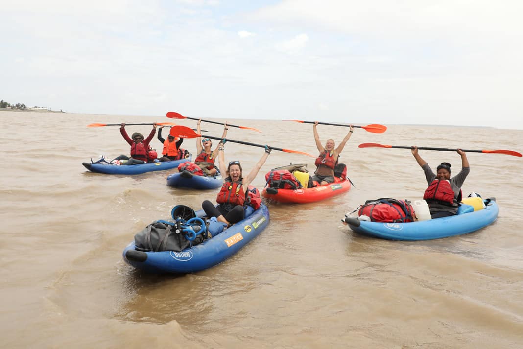 4 woman paddling inflatable kayaks
