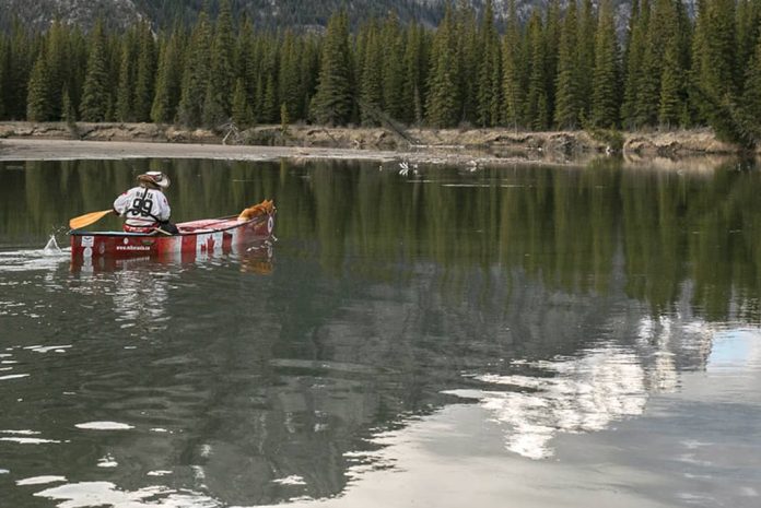 Mike Ranta paddling on his canoe trip with his dog Spitzii