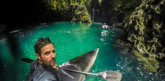 kayaker in emerald water
