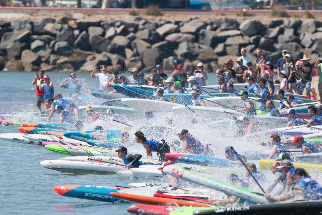 several paddleboard racers at the starting line