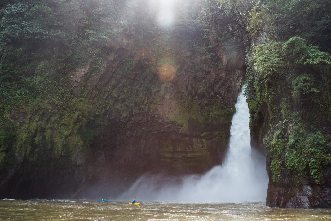 Whitewater kayaking near a picturesque waterfall in Mexico