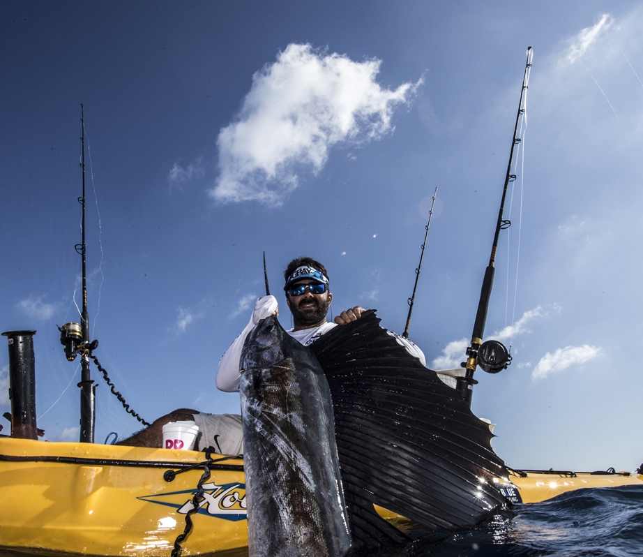A kayak angler holding a sailfish Photo by: Extreme Kayak Fishing