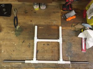 An image of an assembled kayak cart from made of PVC pipe.