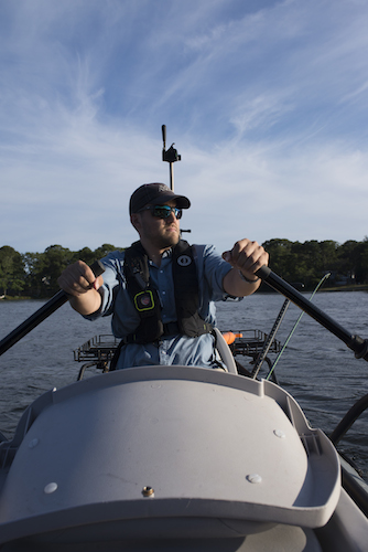 man rows the Flycraft Stealth inflatable fishing boat