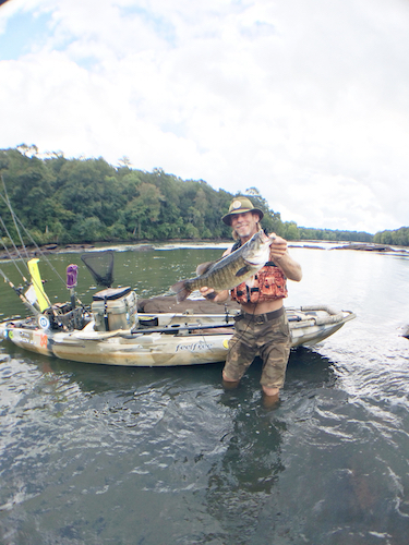 Eddie McRae holds up a big Chattahoochee River shoal bass.