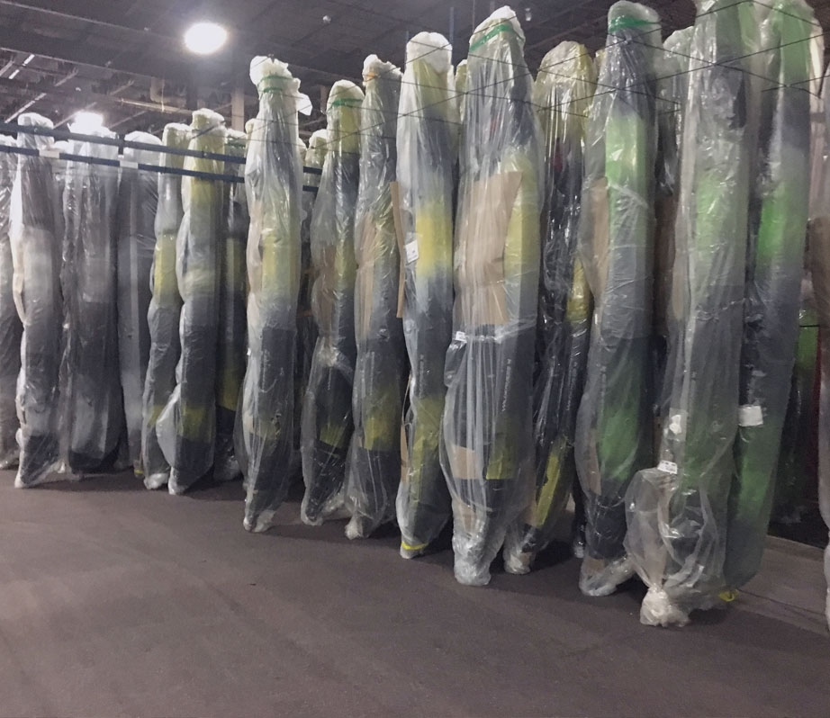 A stack of kayaks in a warehouse. Photo Courtesy of Confluence Outdoors