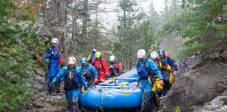 students from Algonquin College in Pembroke, portaging a raft.