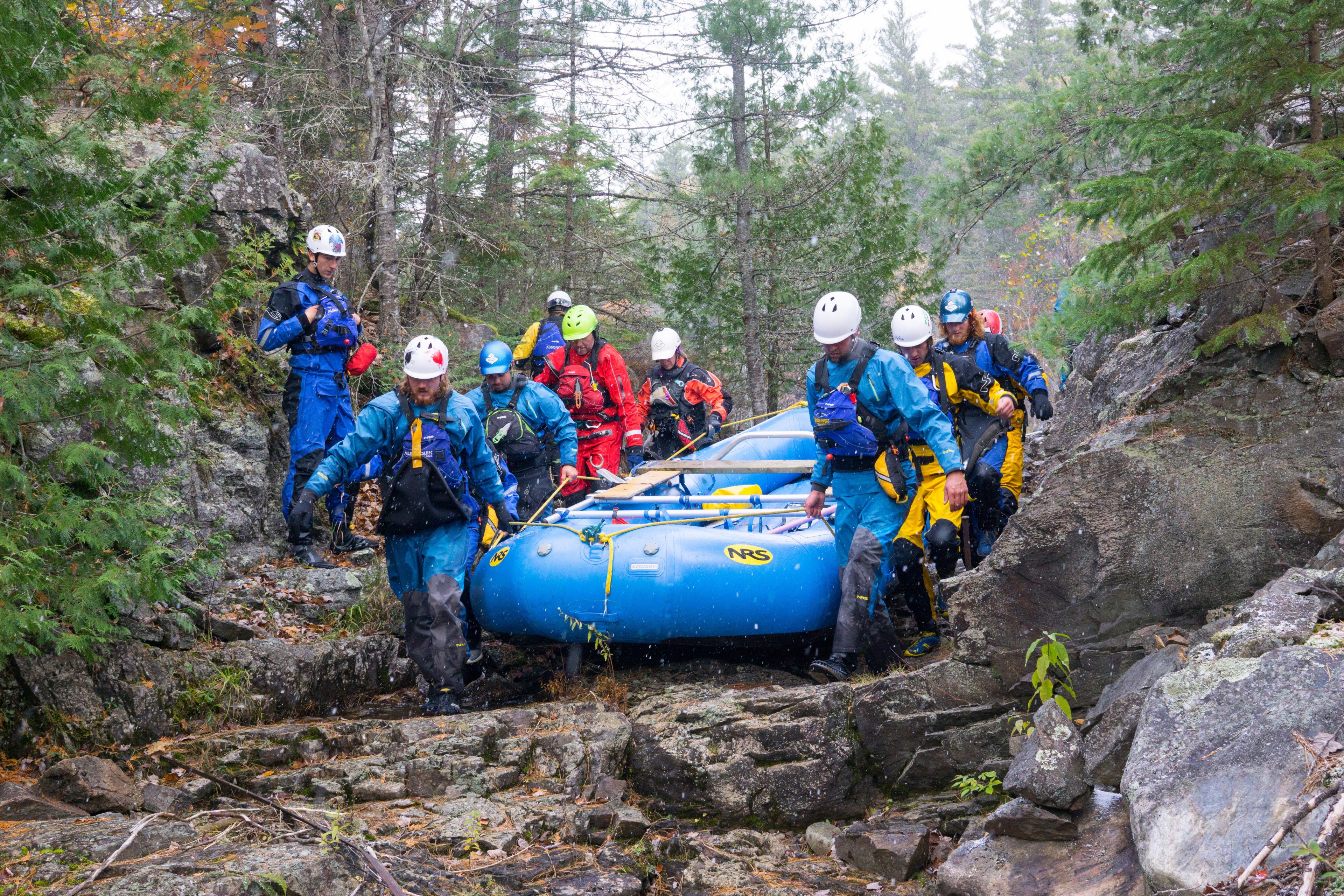 students from Algonquin College in Pembroke, portaging a raft.