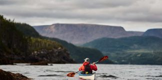 Man paddles a kayak in the water