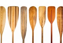 several wooden and ash canoe paddles lined up