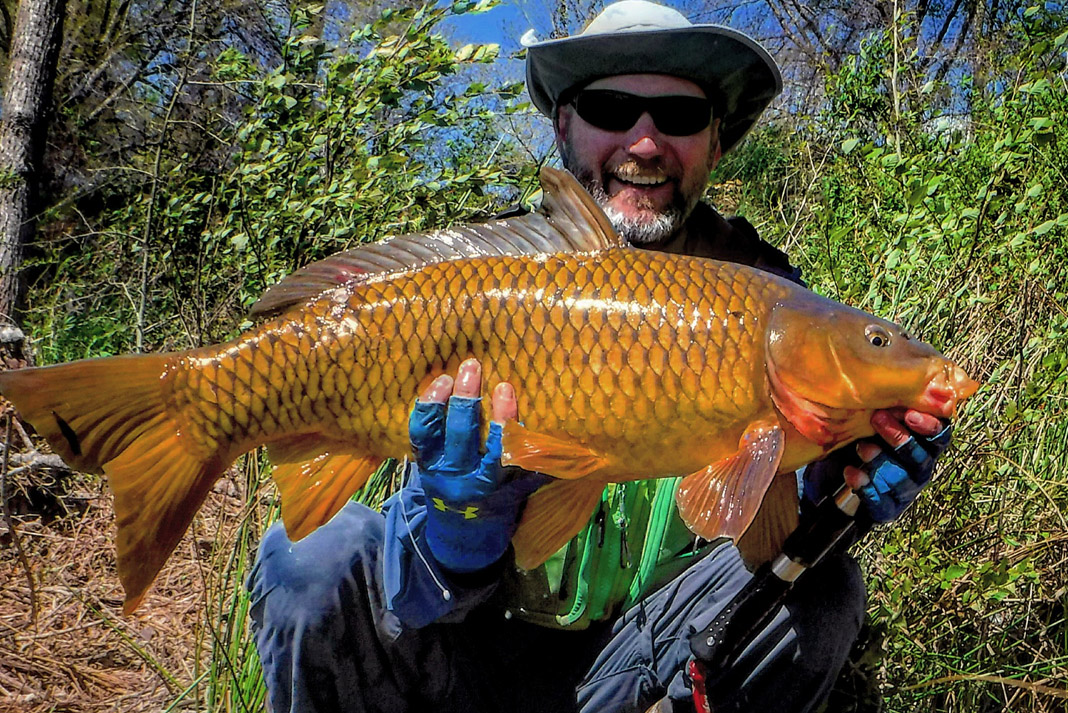 man holding a large orange fish